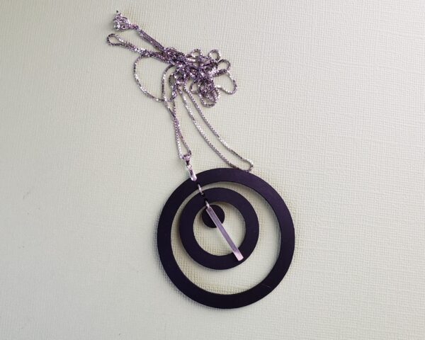 Acacia Small Black Leather Pendant Two Large Circles One Small Disk Linked by Sterling Silver Rings Finished by One Inch Solid Silver Bar 36 inch Sterling Silver Chain Double 18 inch Chain Stamped 925 Silver Lobster Clasp Grey Background