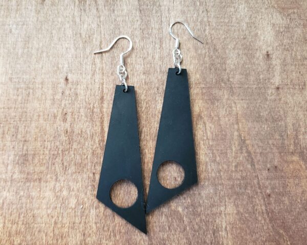 Aria Earrings Black Leather Large Stylized Diamond Shaped Earrings Off Centered Circle Cutout Sterling Silver Components Stamped 925 Silver Ear Wire Wood Background